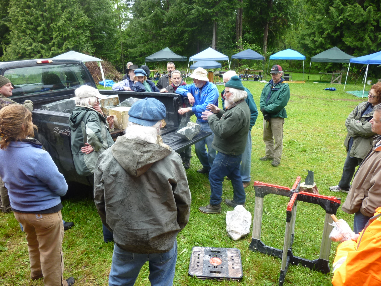 Having brought the stone, Randy Zieber leans on his truck at the far left, while Tracy Powell takes center stage to talk about the various types. 