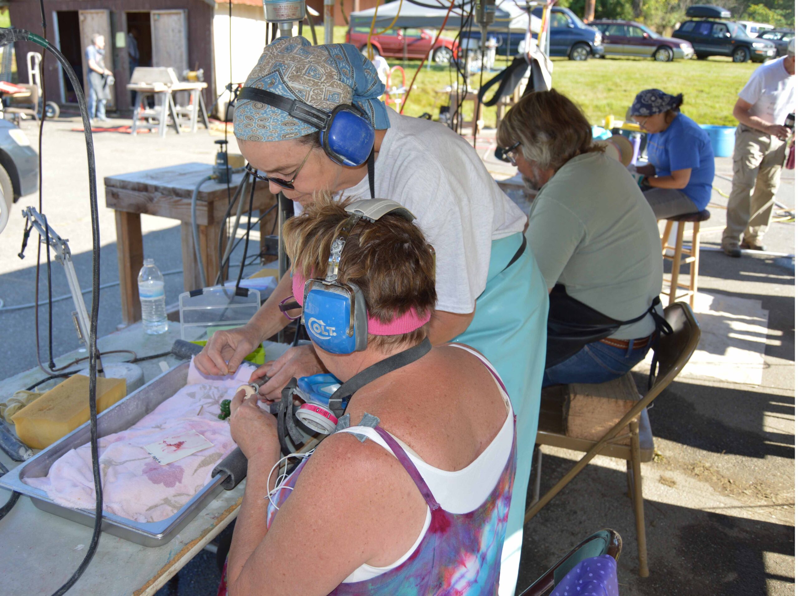 Deborah Wilson helping another student learn about jade carving.